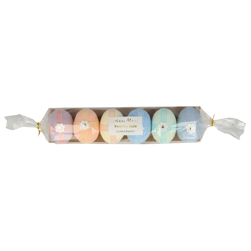 Meri Meri crepe paper wrapped surprise eggs lined up in clear plastic sleeve packaging.