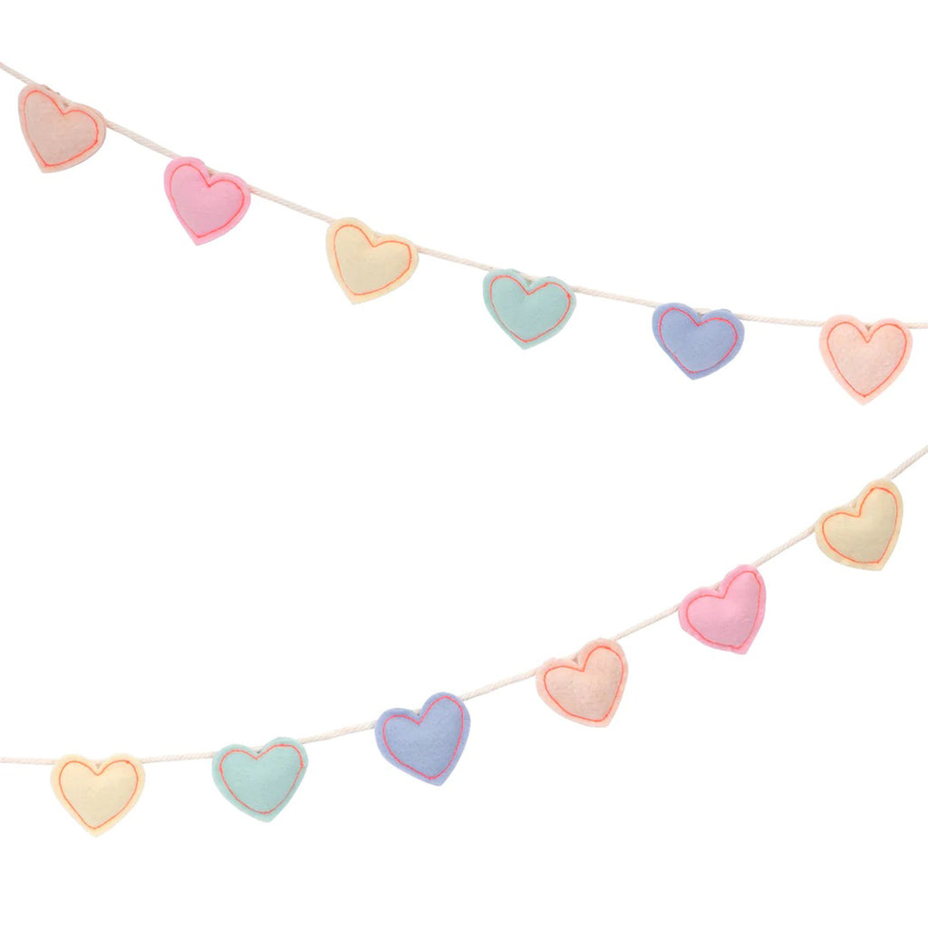 Meri Meri puffy felt hearts with neon coral stitching in pastel colors attached to a natural color braided cord, doubled back.