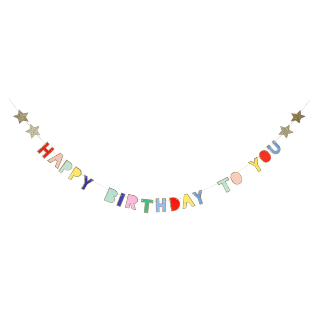 meri meri hanging mini garland with "happy birthday to you" spelled out in bright colored letters with gold glitter metallic outline, 2 glittery gold stars on either end and strung on a gold cord