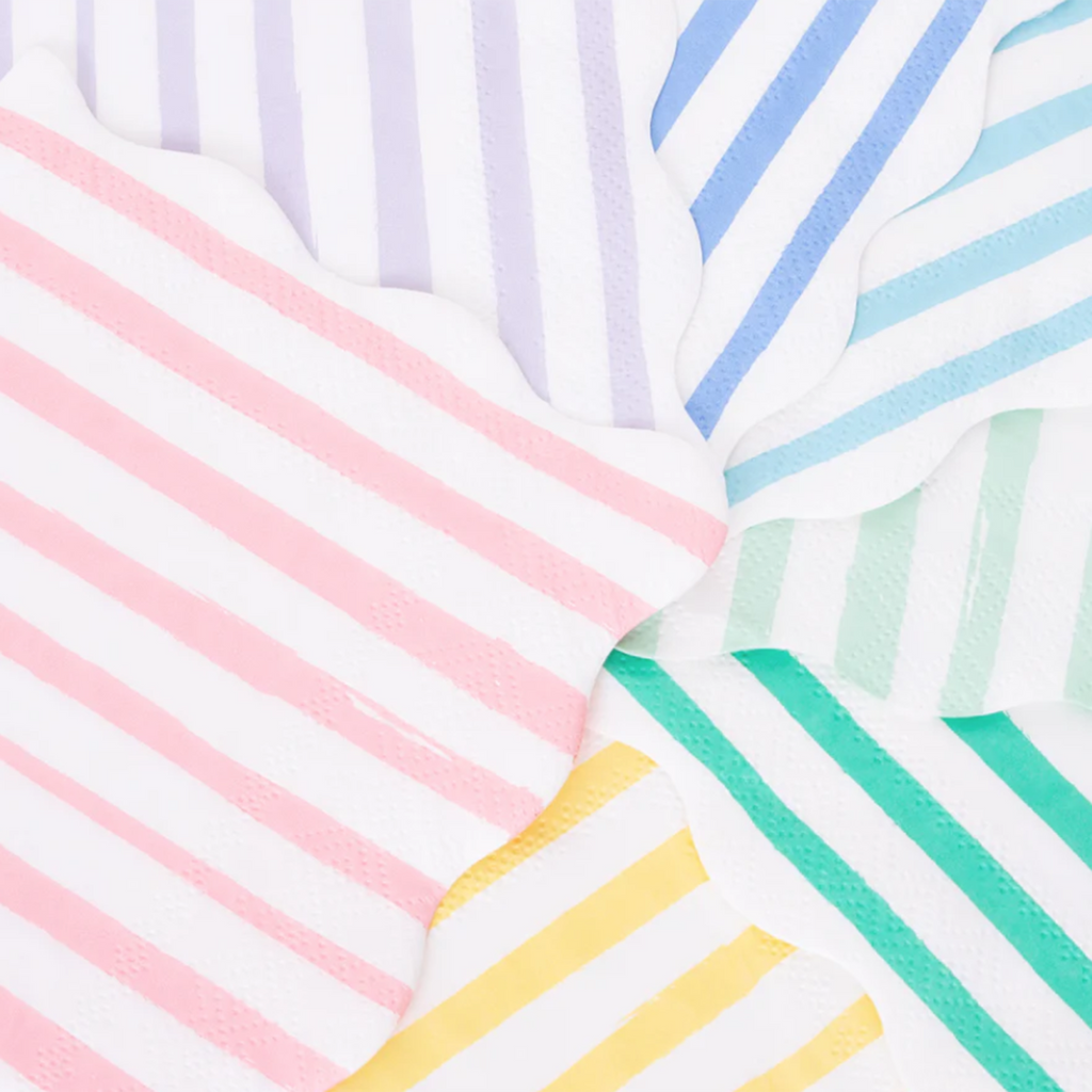 meri meri small napkins with scalloped edges and stripes in red and white, pink and white, yellow and white, lilac and white, blue and white, aqua and white, mint green and white and green and white arranged in a circular fan order