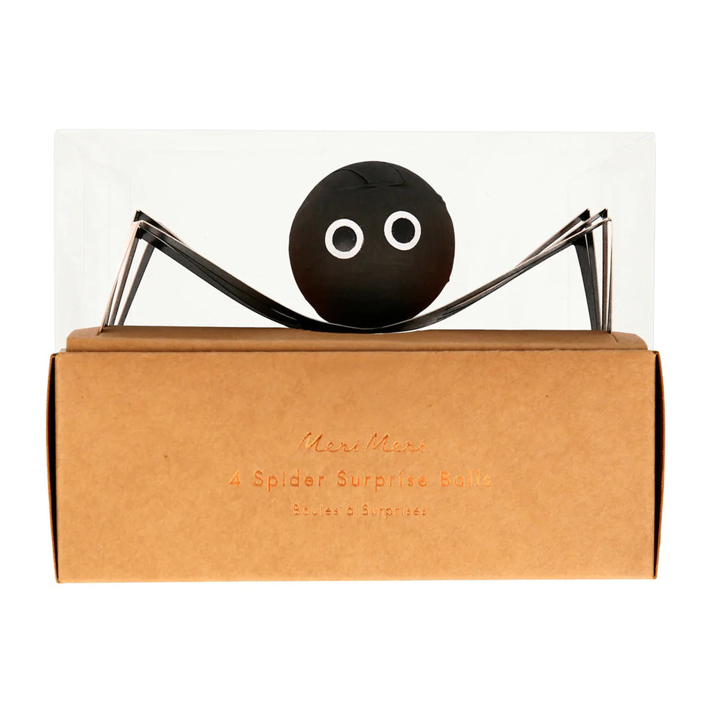 Spider shaped halloween surprise ball in packaging with kraft paper base and clear plastic lid.