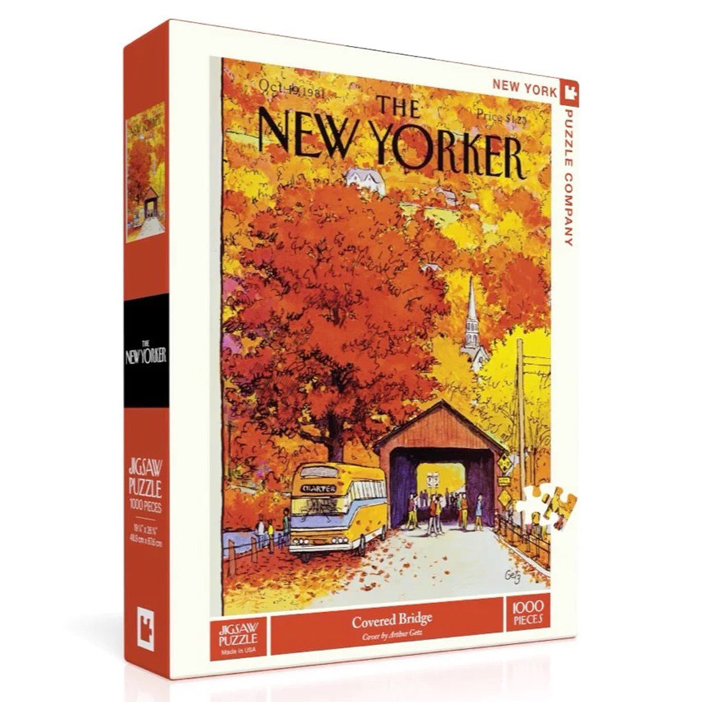 Front and side angle of box for a 1000 piece jigsaw puzzle of a New Yorker magazine cover with tourists from a yellow charter bus wandering around a small covered bridge surrounded by fall foliage and a church steeple rising above it on hill.
