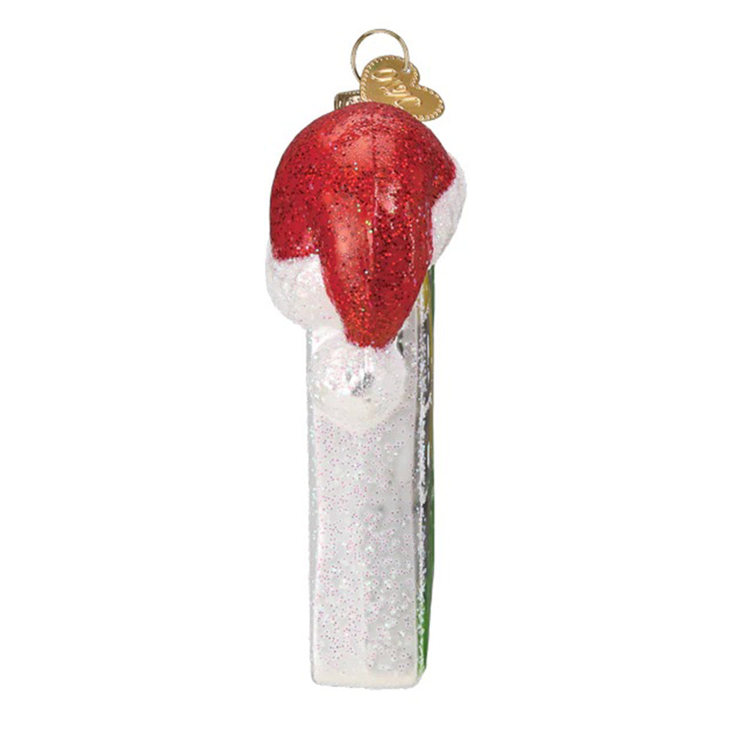 Side view of a glass holiday tree ornament with a white glitter side and a santa hat hanging on the top.