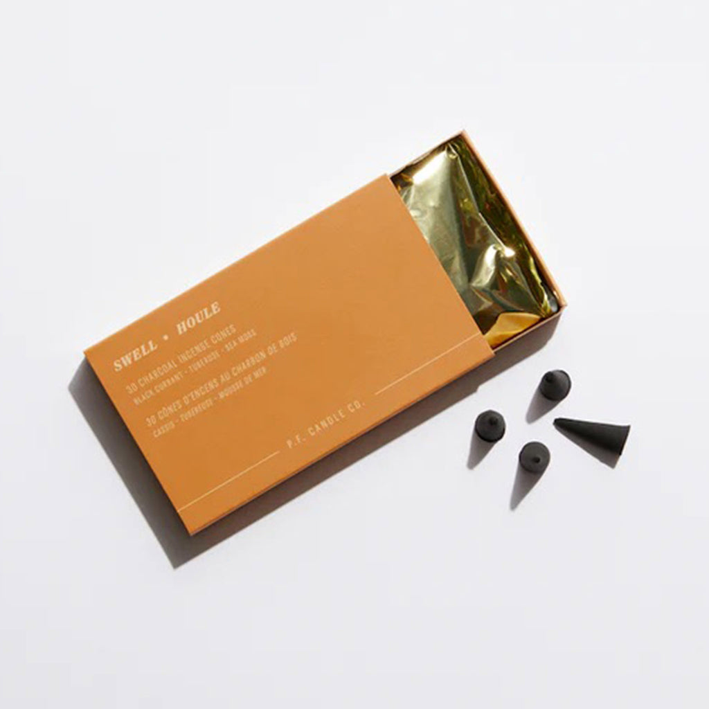P.F. Candle Co. Swell Scented Sunset Incense Cones in orange matchbox packaging with gold foil lining.