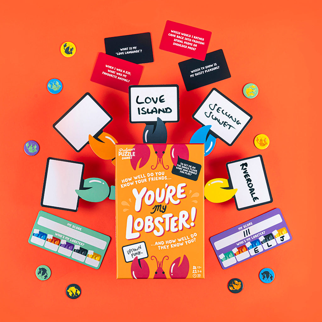 Professor Puzzle "You're my Lobster" game in orange box packaging with sample cards, scorecards and tokens on an orange background.