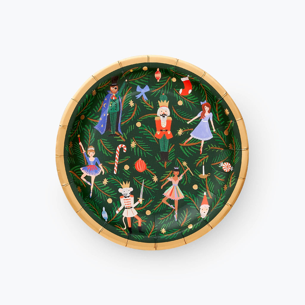 Small paper holiday party plate with Nutcracker characters with evergreen leaves on a dark green background with a gold edge.