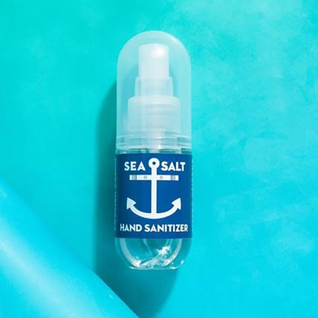 Swedish Dream Sea Salt Hand Sanitizer in 2 ounce clear spray bottle with blue and white label on a turquoise backdrop.