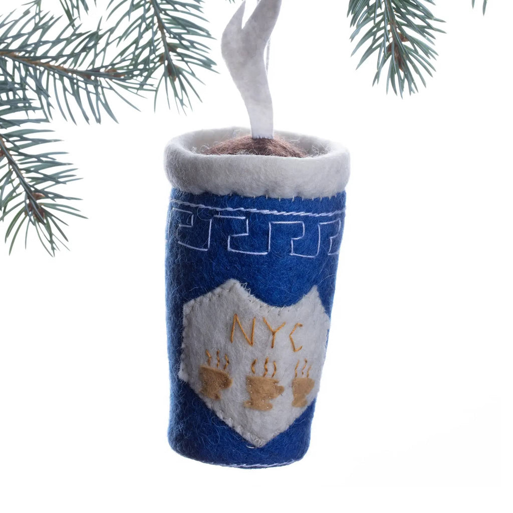 Felt holiday ornament that looks like a greek deli coffee cup hanging from a tree branch 