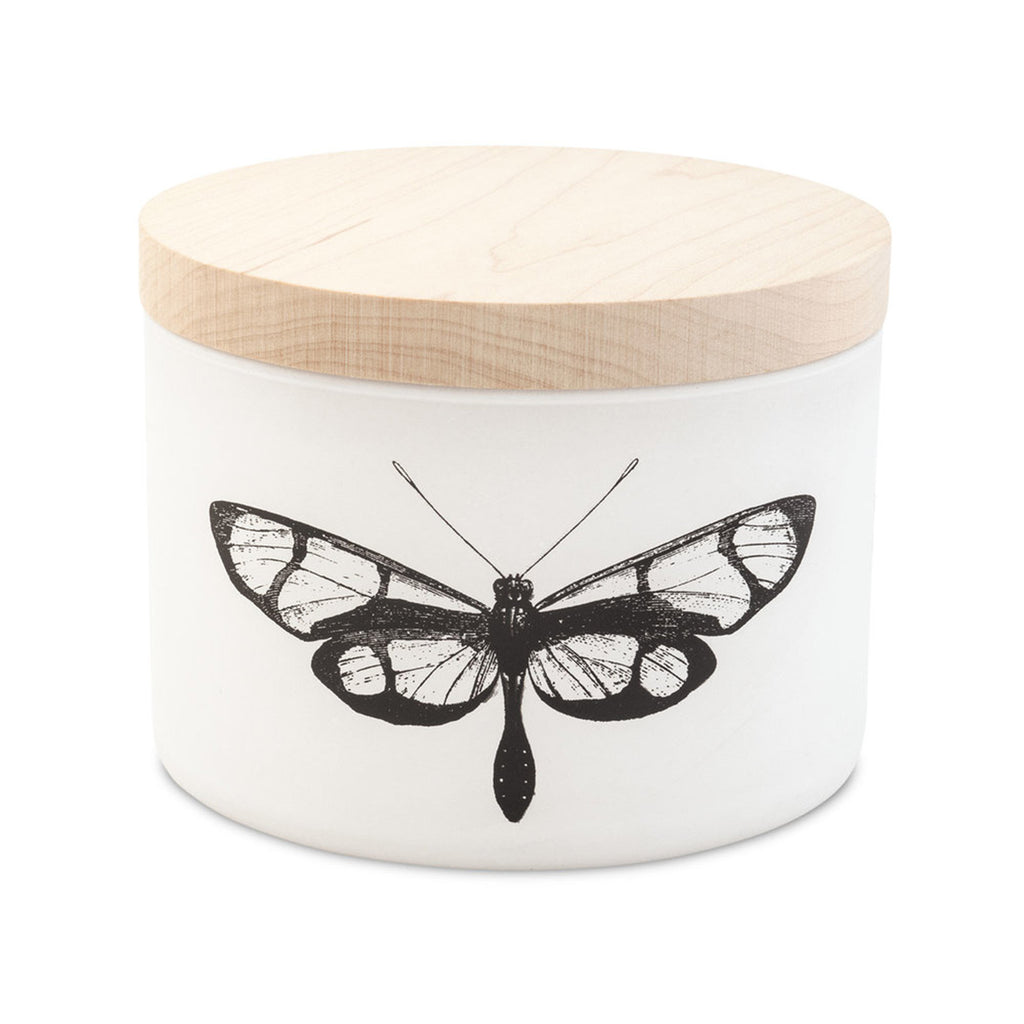 skeem citronella eucalyptus scented three wick soy wax candle in matte white vessel with line drawing of a moth on the front and a wood lid