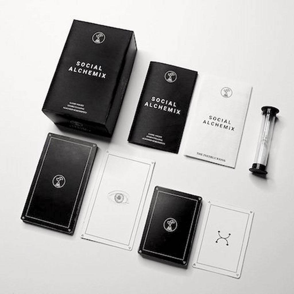 social alchemix game in black box with white lettering and black & white illustrated cards with book of questions and sand timer