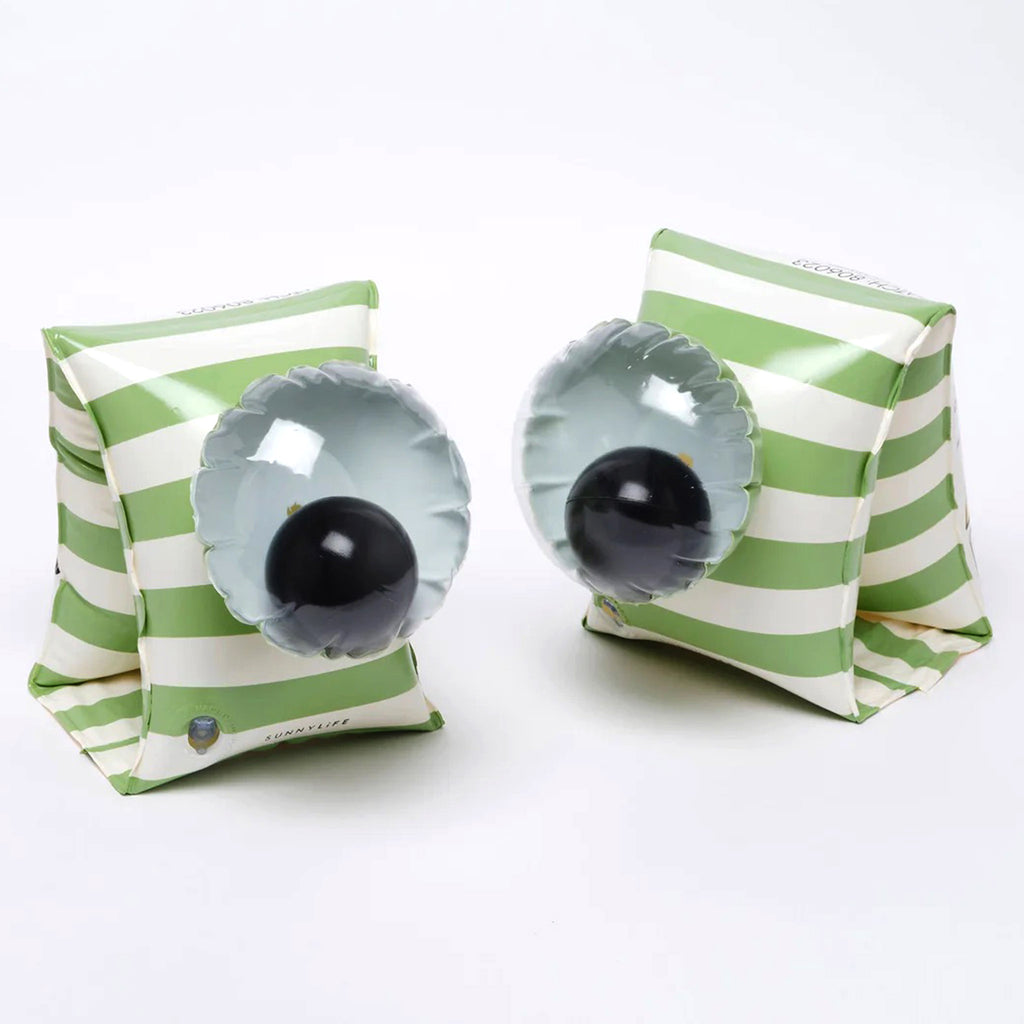 Sunnylife Shark Tribe Inflatable Buddy Float Bands, pair of green & white striped floaties with a 3D googly eye on a white background.