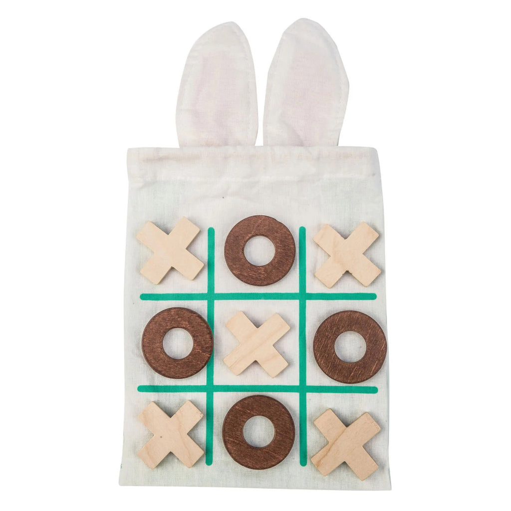 Kids tic tac toe game with dark wood O's and light wood X's on a green grid on the back of the bunny drawstring bag.