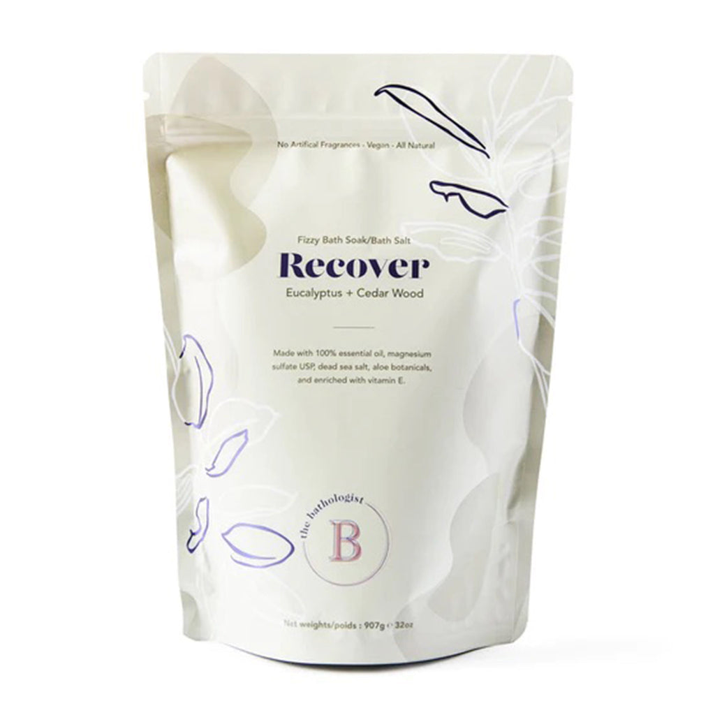 The Bathologist Recover Eucalyptus and Cedar Wood Scented Fizzy Bath Soak in light tan resealable pouch, front view.