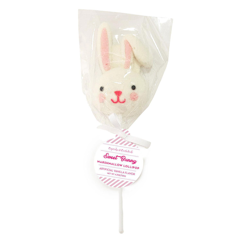 Vanilla flavored marshmallow lollipop in the shape of a bunny head with a floppy ear, black eyes, pink mouth, blush cheeks and ear inset. Cello bag is secured with a white grosgrain ribbon bow.