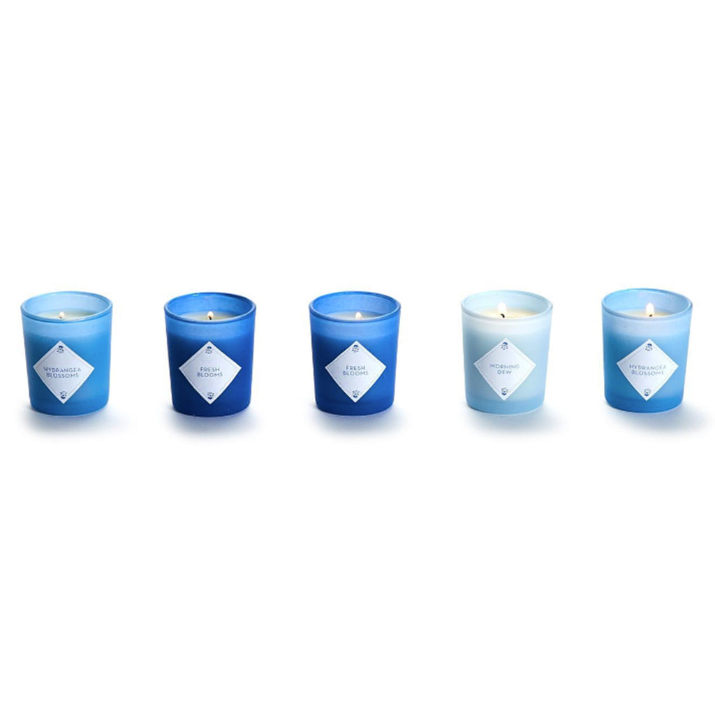 Two's Company Hydrangea Votive Candle Set, 5 candles in shades of blue side by side and lit.