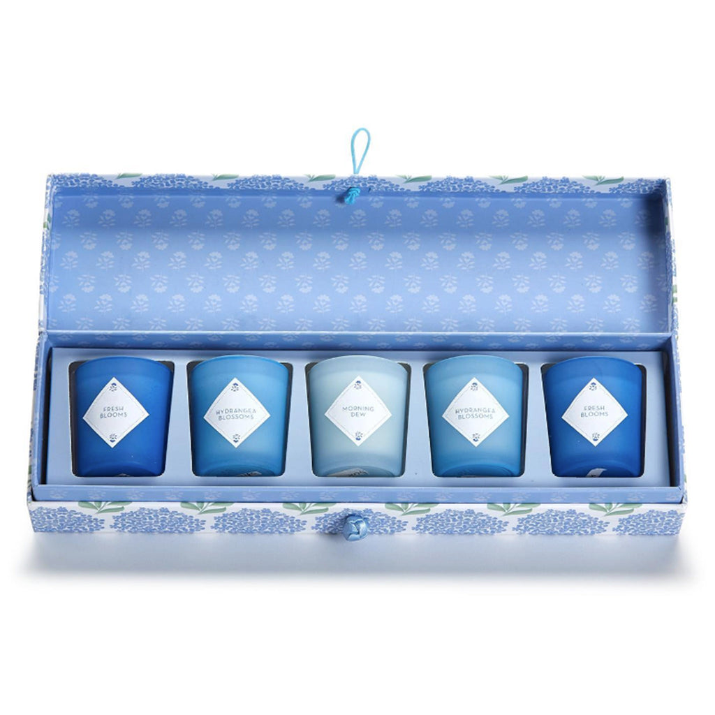 Two's Company Hydrangea Votive Candle Set in box packaging, lid is open to show the 5 votive candles in shades of blue.