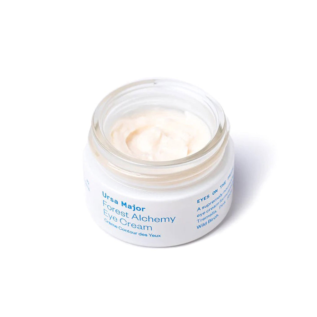 Forest alchemy eye cream in white jar with blue lettering, overhead view cap off.