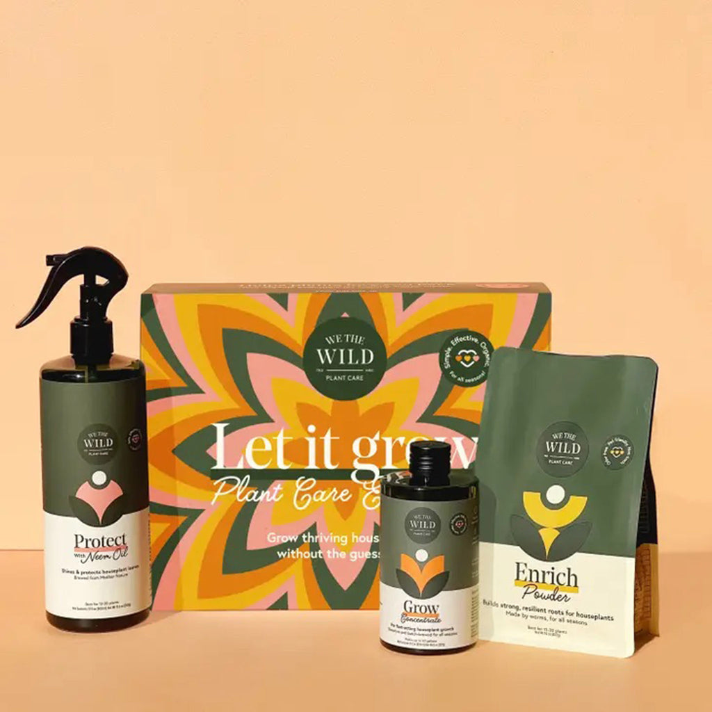 We the Wild Let it Grow Plant Care Essentials kit, protect spray, grow concentrate and enrich powder; in front of box packaging with orange, yellow, pink and green graphic flower design on front.