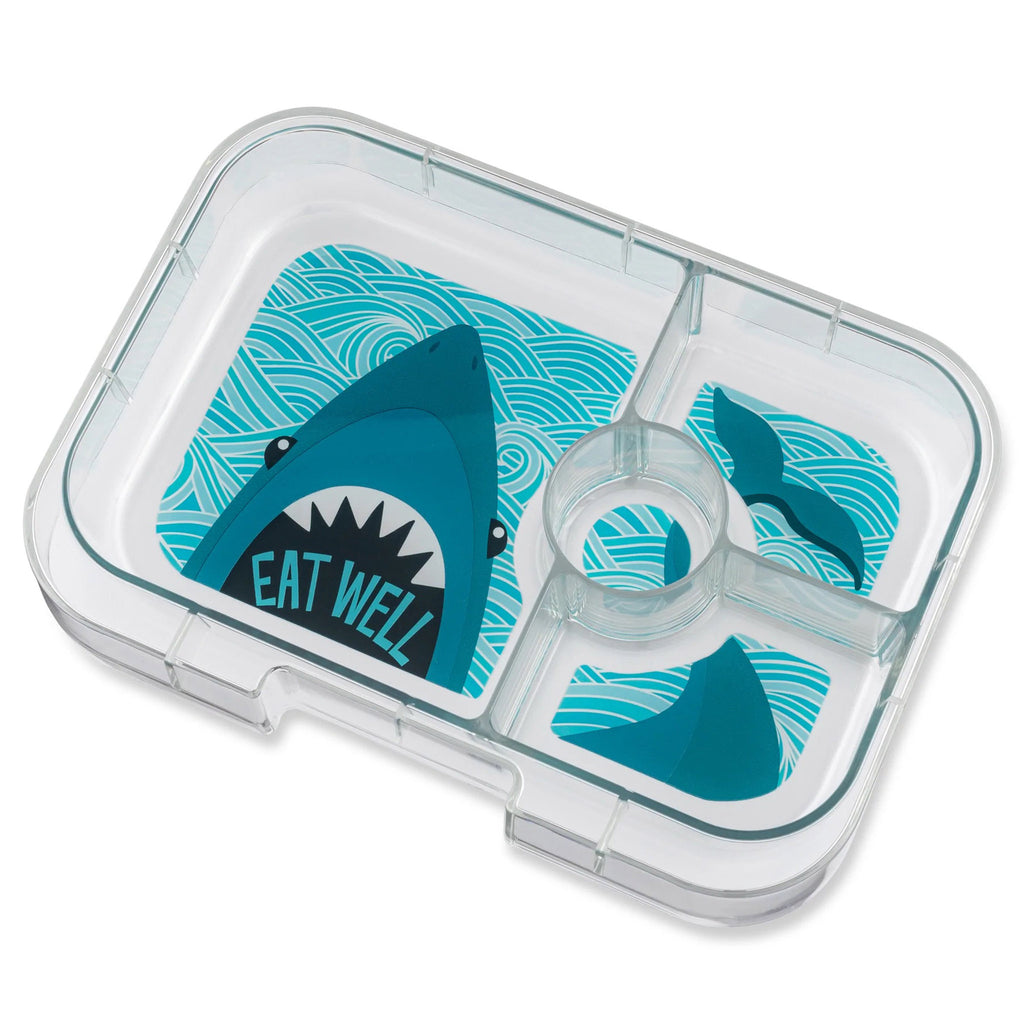 yumbox lunch box clear inner tray divided into 4 compartments with an illustration of a shark head in large compartment with "eat well" in its mouth and rest of its body and tail illustrated in smaller compartments to the right