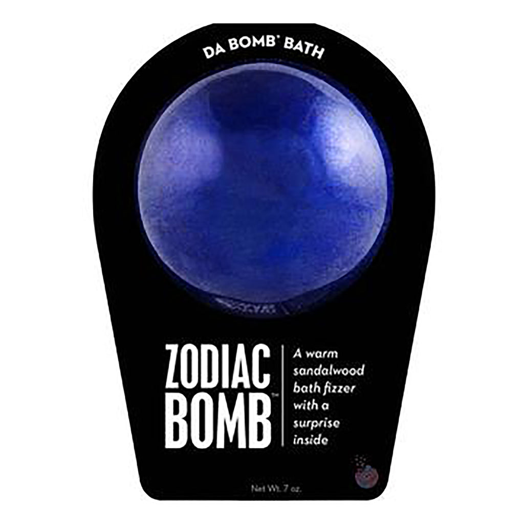 Da Bomb Zodiac Bomb, dark blue bath fizzer with sandalwood scent and a surprise inside, in black clamshell packaging, front view.